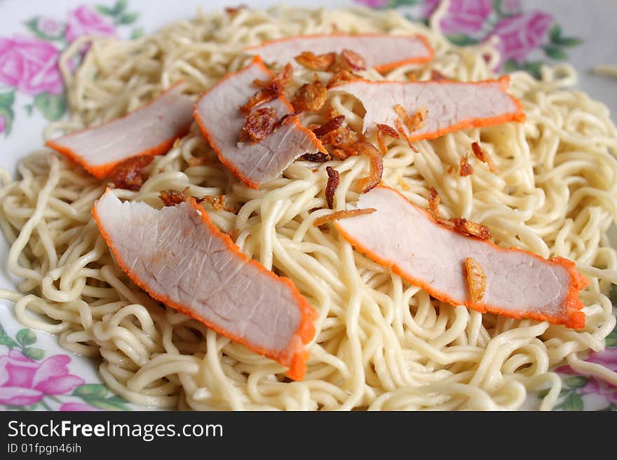 Closeup of Kampua mee (Sarawak Chinese noodles) with roasted pork meat.