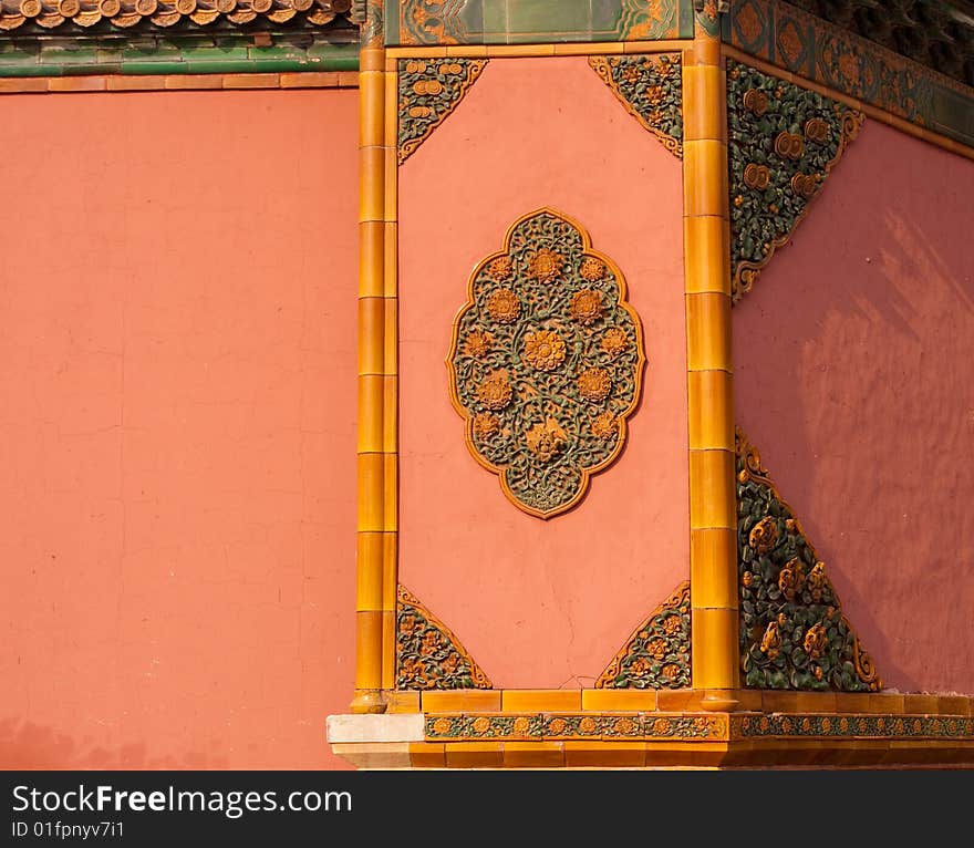 Golden relief on red wall in forbidden city