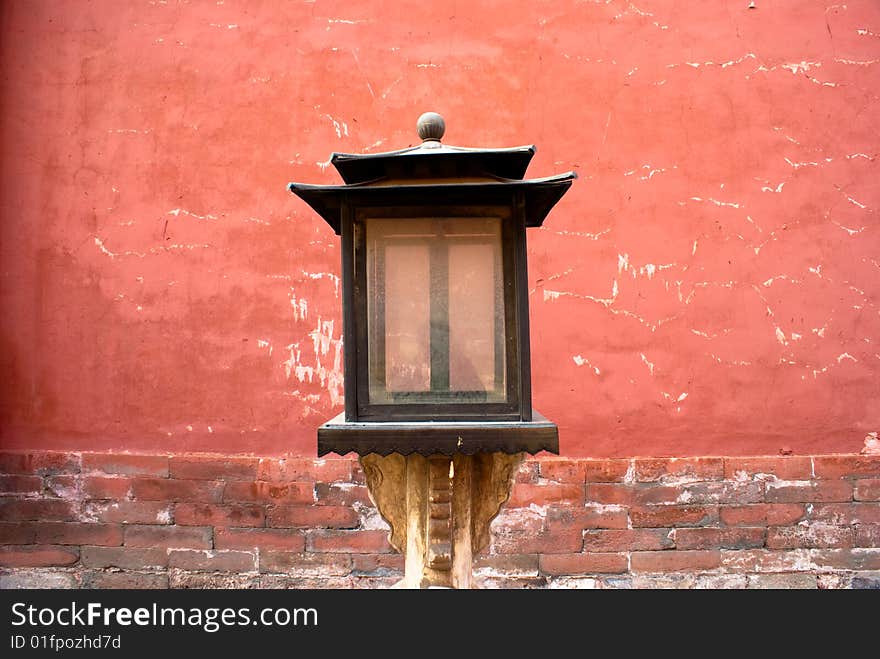 Antique wood lamp beside red wall of the forbidden city. Antique wood lamp beside red wall of the forbidden city