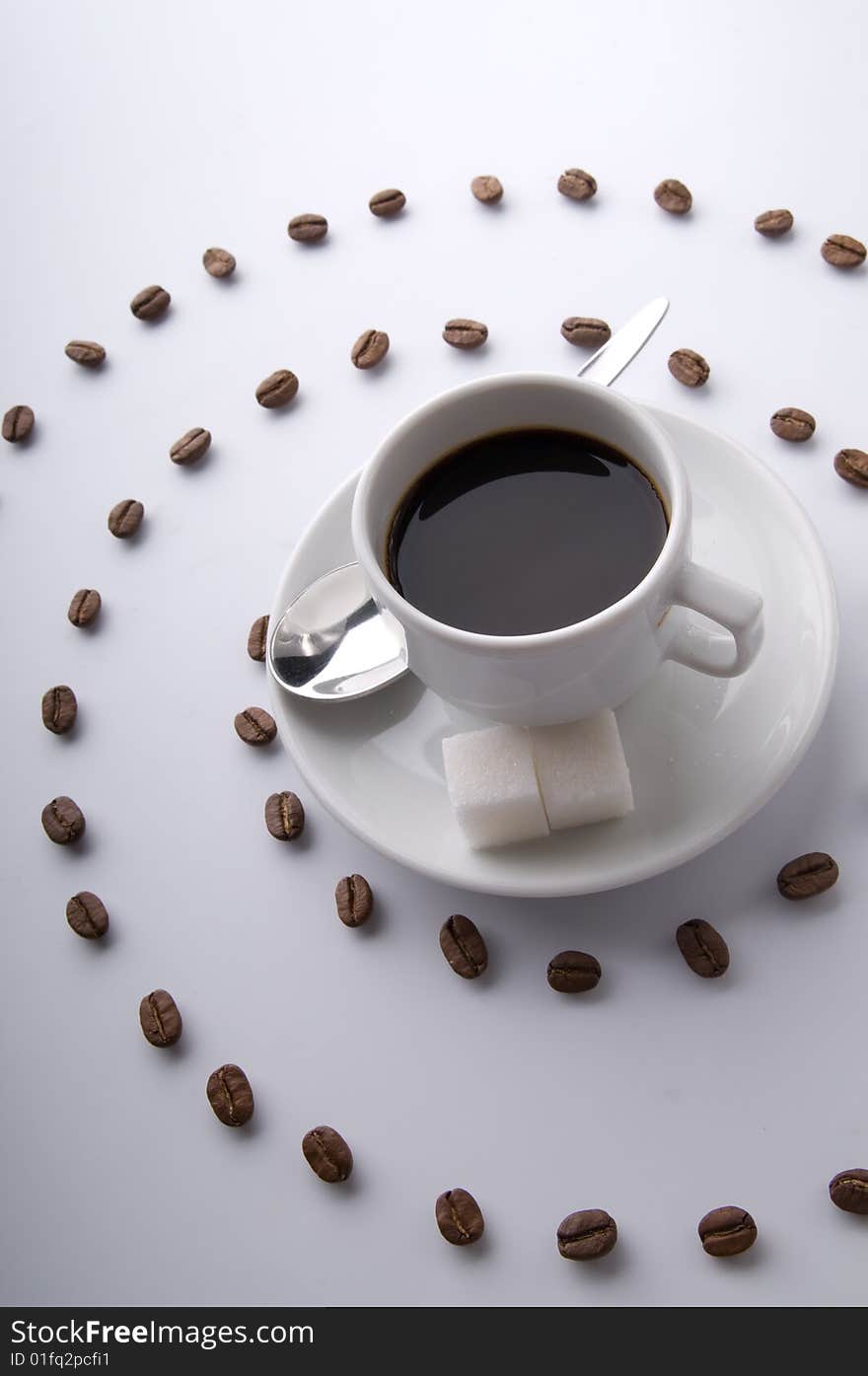 Coffee cup and spiral of grains