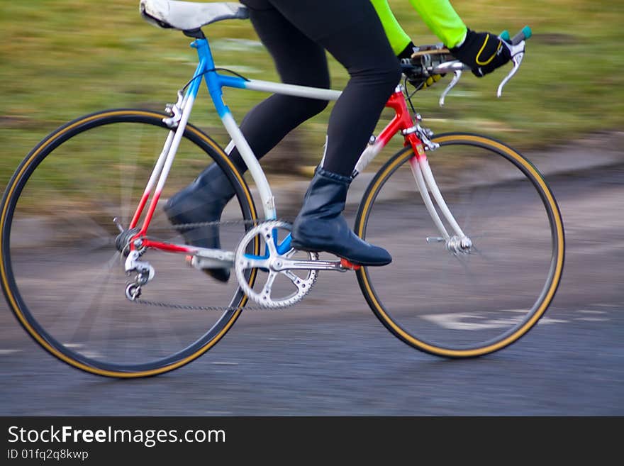 Cyclist pedaling motion blur shot. Cyclist pedaling motion blur shot