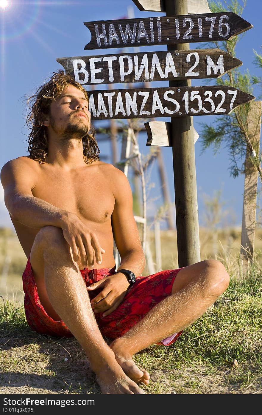 The young man rests until a roadside plate. The young man rests until a roadside plate.