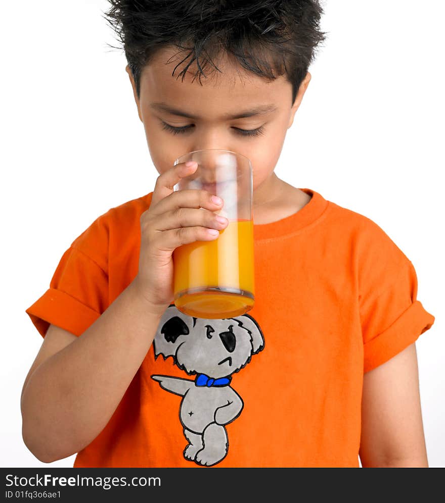 Indian boy drinking a glass of juic