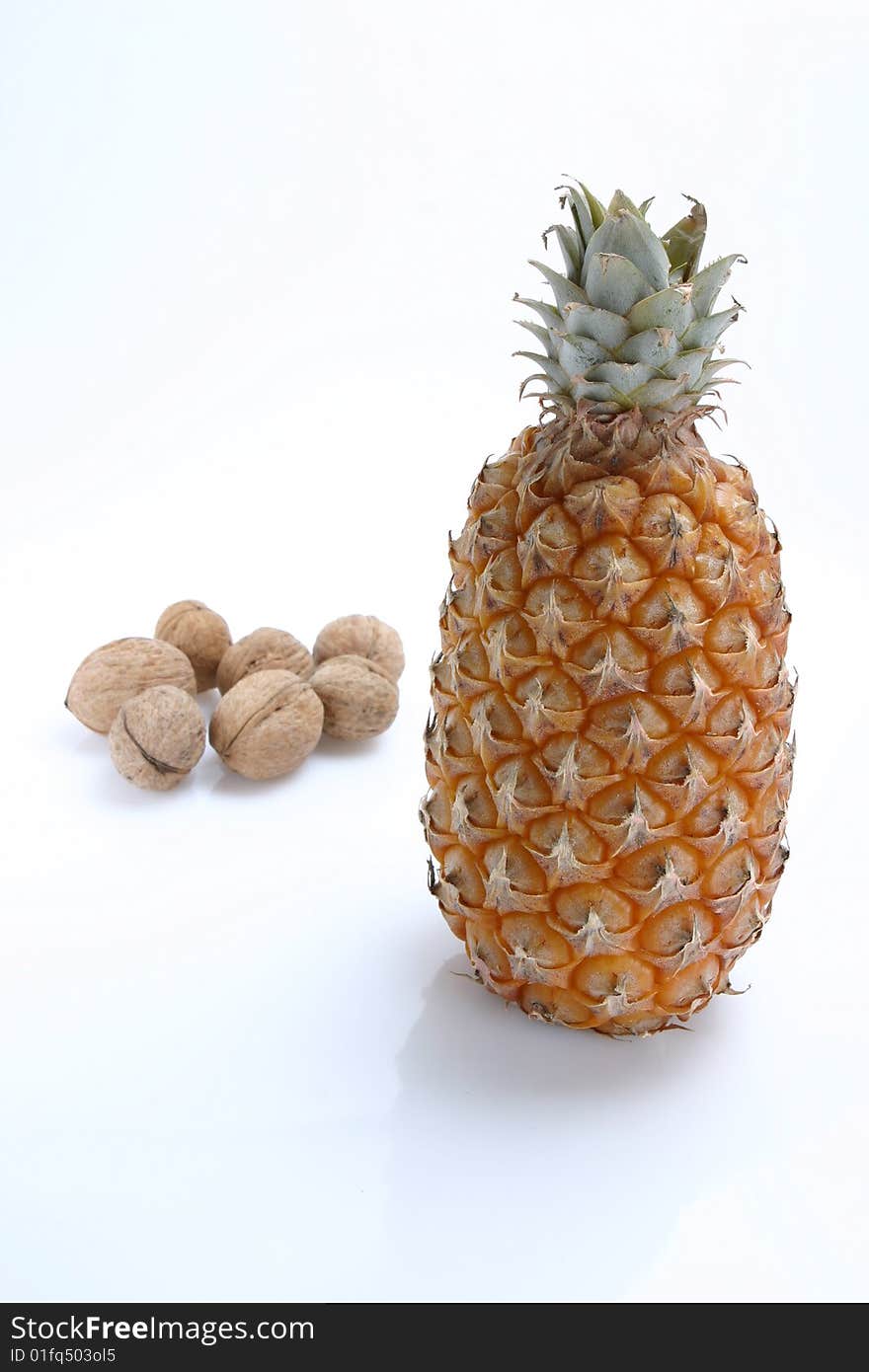 The isolated pineapple and walnut on the white