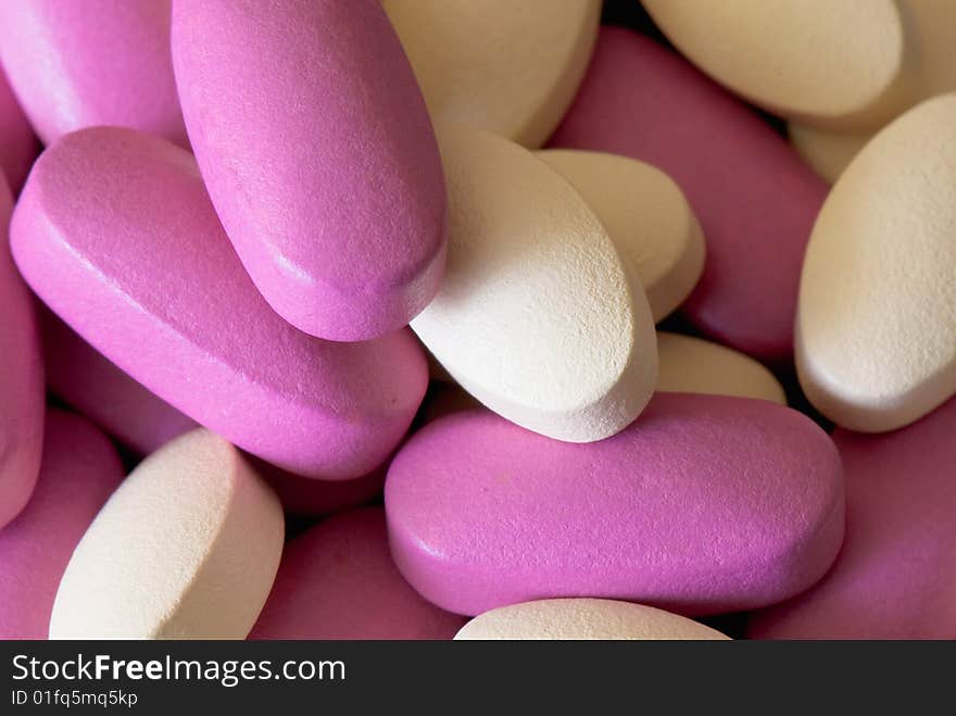 Colored oblong pills on the isolated background