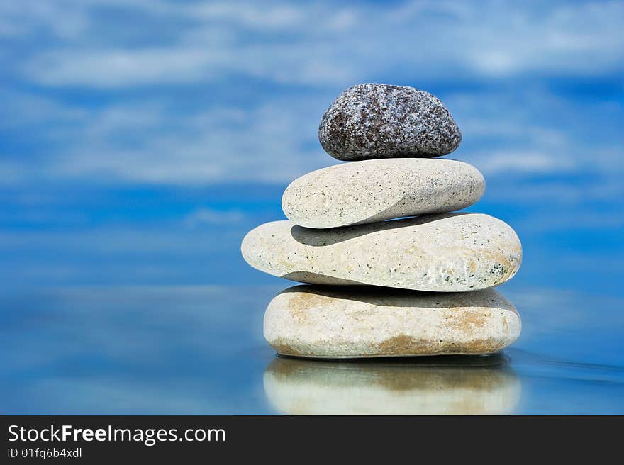 White sea pebble and one black stone with top. White sea pebble and one black stone with top