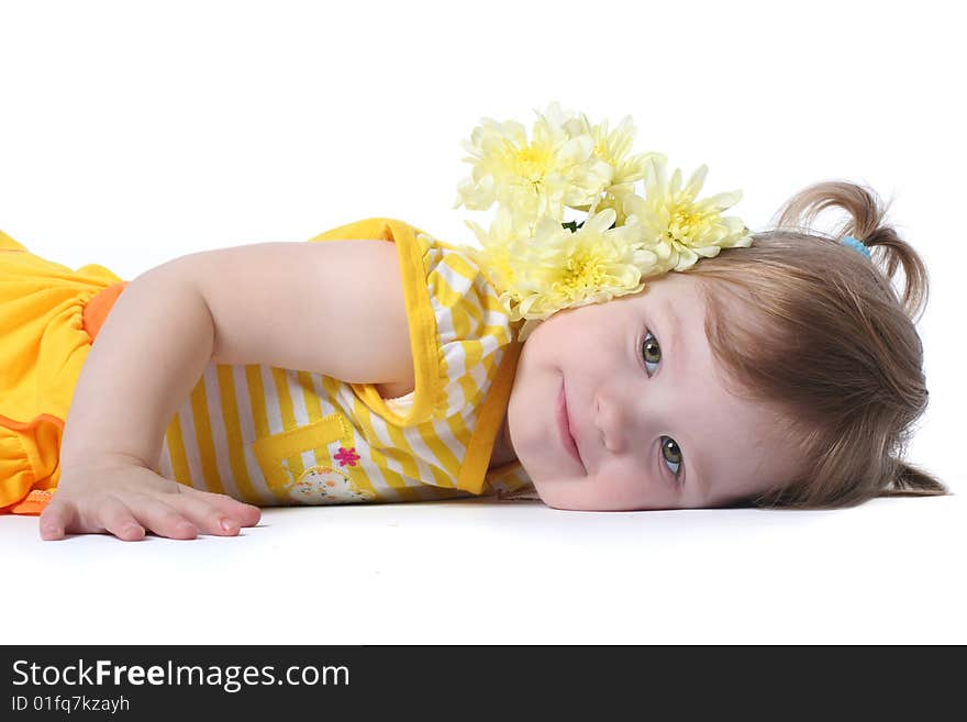 Funny little girl relaxing with yellow flowers