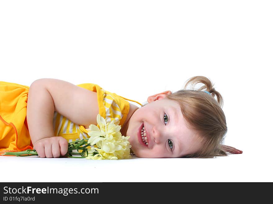 Funny little girl relaxing with yellow flowers