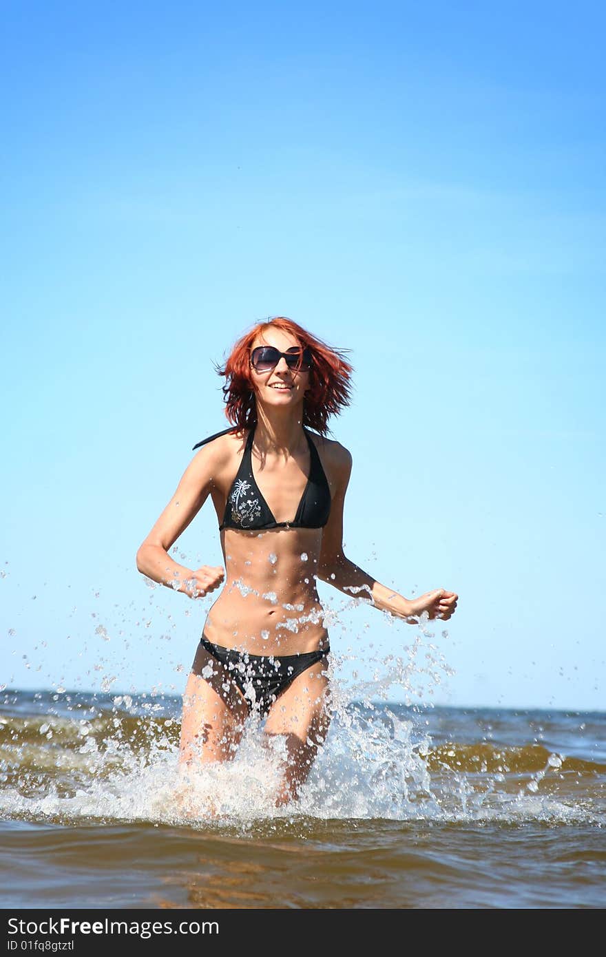 Beautifil girl running on the sea. Beautifil girl running on the sea