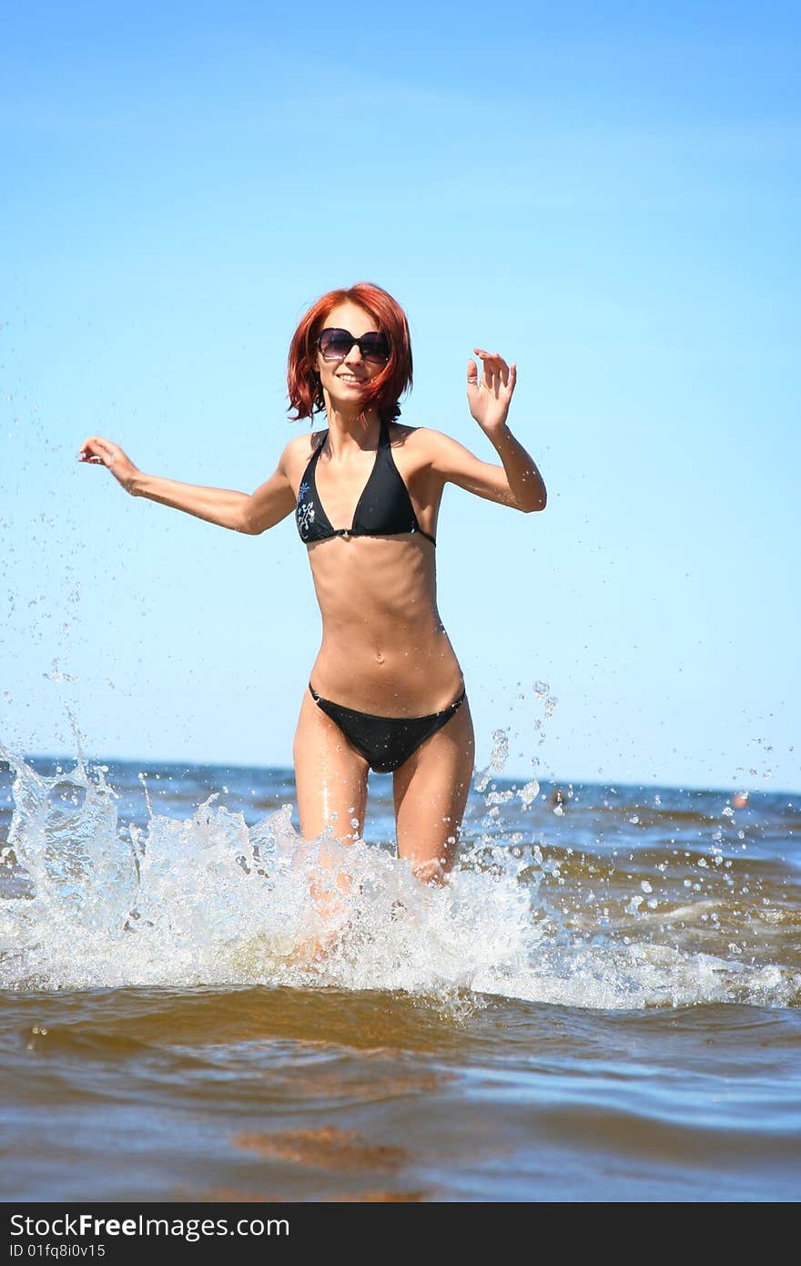 Beautifil girl running on the sea