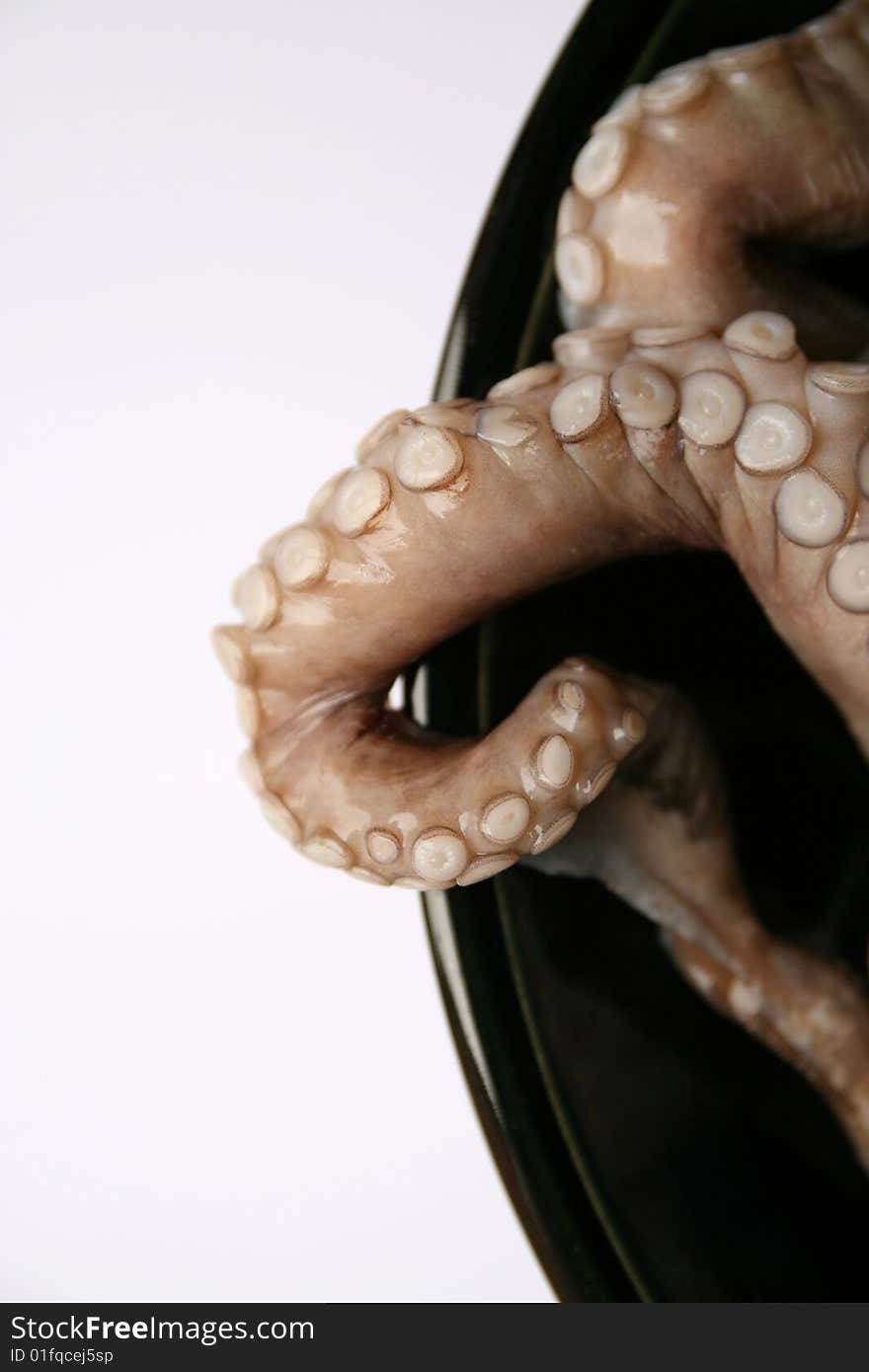 Octopus tentacles on a black dish