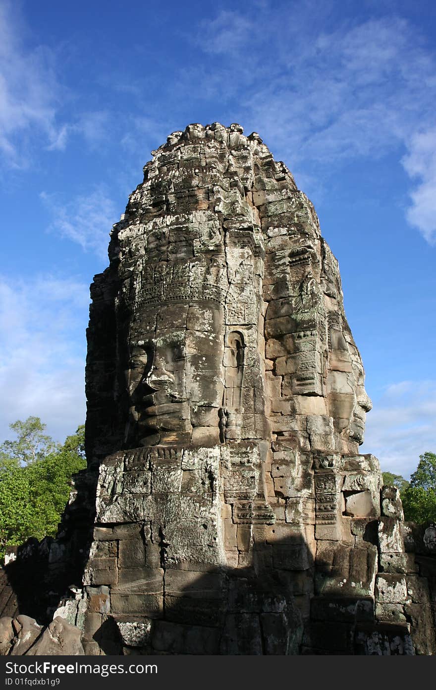 Face carved in rock at Bayon Temple at Angkor in Cambodia. A temple from the 12th century. Face carved in rock at Bayon Temple at Angkor in Cambodia. A temple from the 12th century.