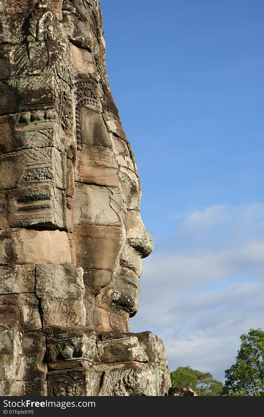 Face carved in rock at Bayon Temple at Angkor in Cambodia. A temple from the 12th century. Face carved in rock at Bayon Temple at Angkor in Cambodia. A temple from the 12th century.