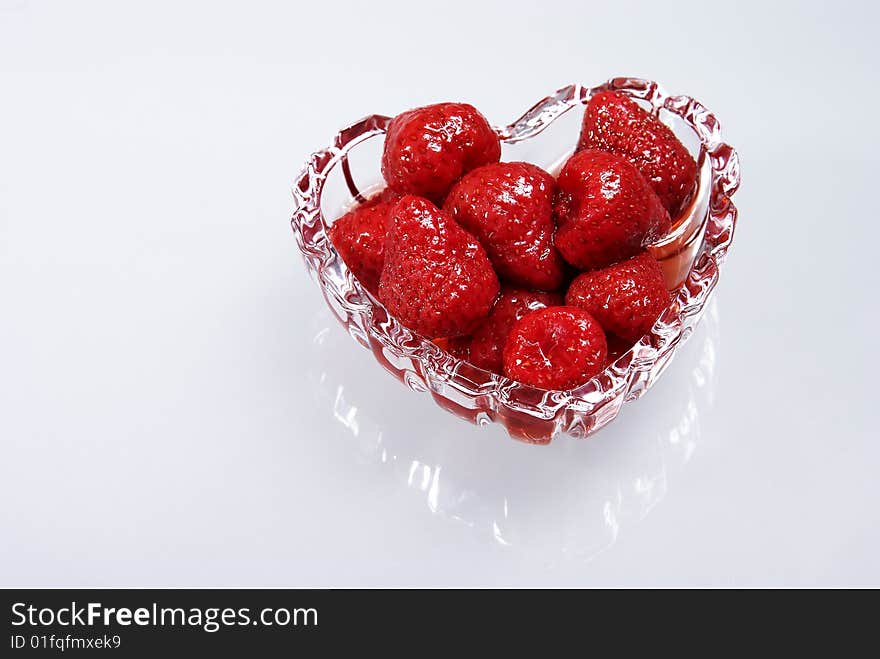 Strawberry in a syrup in glass heart