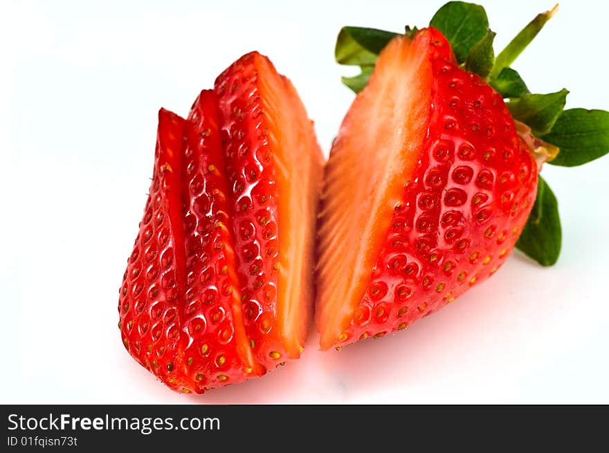 Fresh ripe strawberry cutted into pieces on white background. Fresh ripe strawberry cutted into pieces on white background