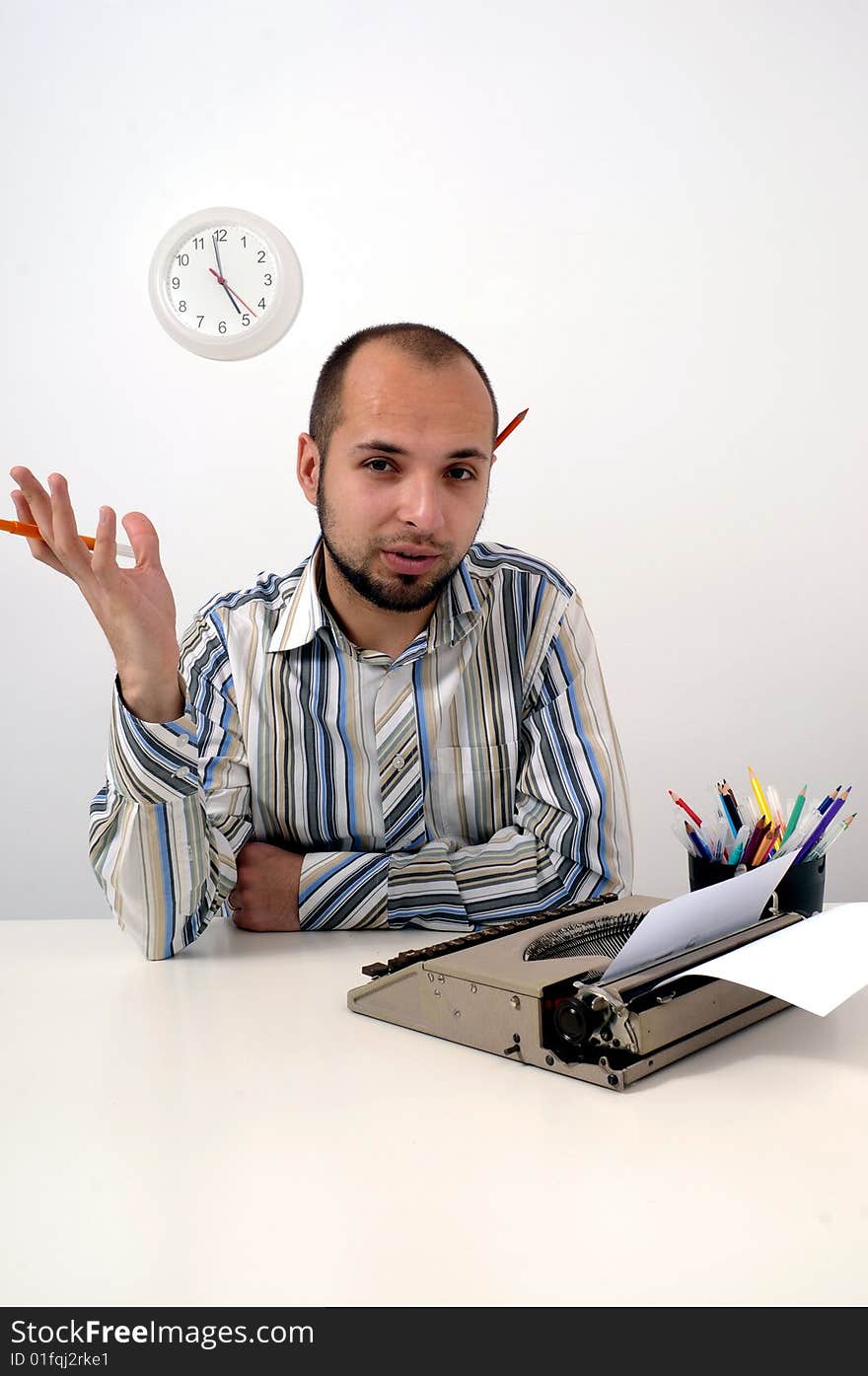 Man typing a document on an antique typewriter in an office. Man typing a document on an antique typewriter in an office