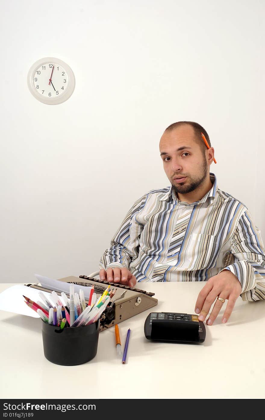 Man typing a document on an antique typewriter in an office. Man typing a document on an antique typewriter in an office