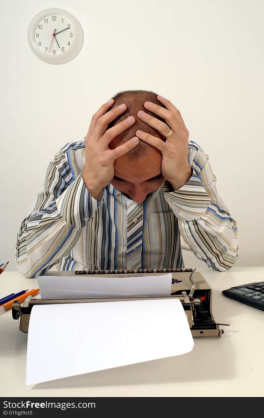 Man typing a document on an antique typewriter in an office. Man typing a document on an antique typewriter in an office