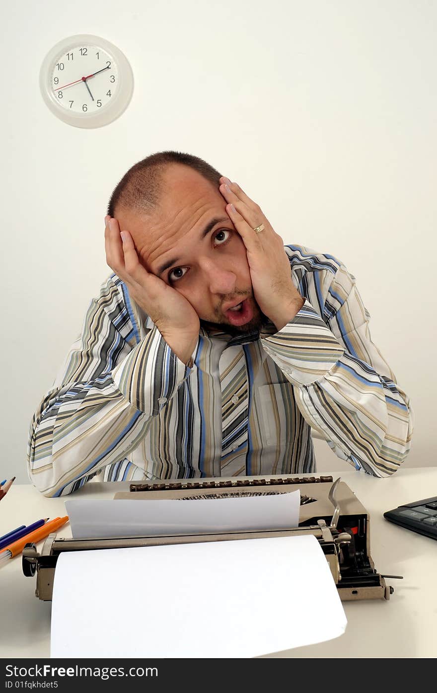 Man typing a document on an antique typewriter in an office. Man typing a document on an antique typewriter in an office