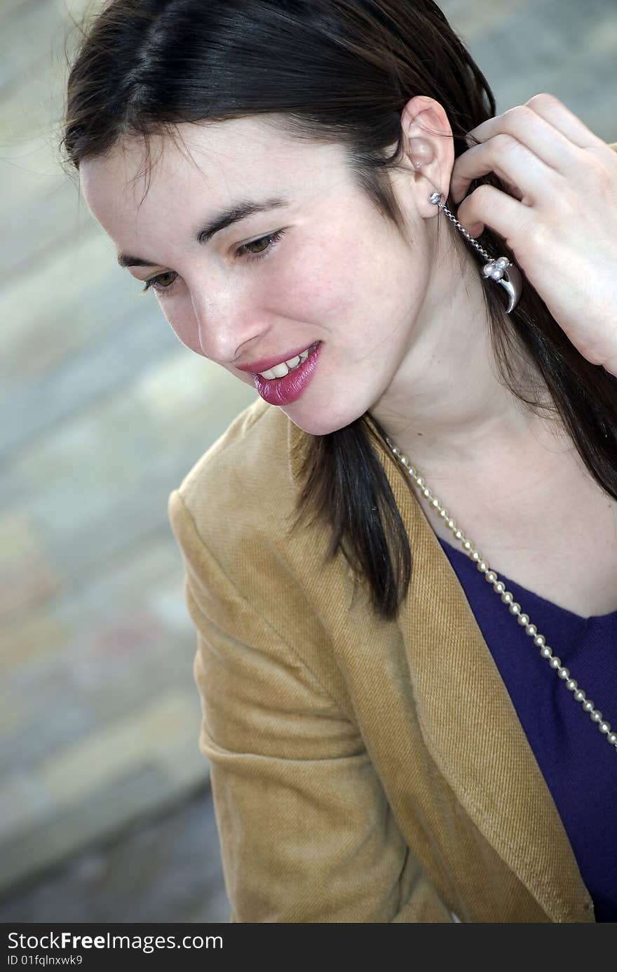 Young woman smiling with hand on her hair