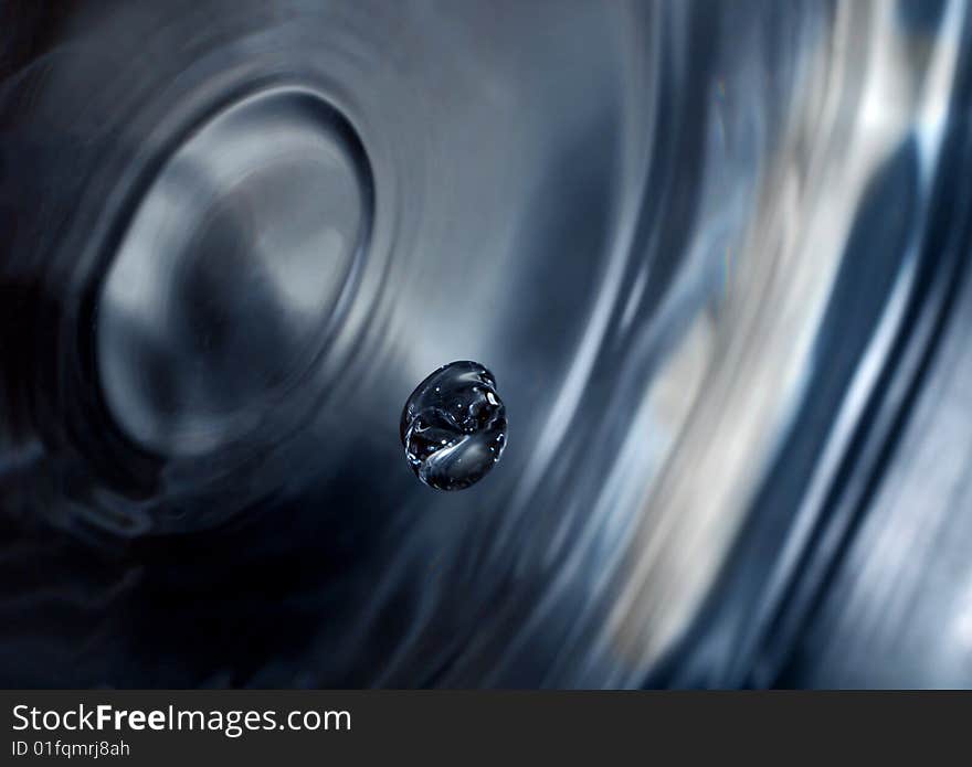 Water dripping into the water droplet. Water dripping into the water droplet