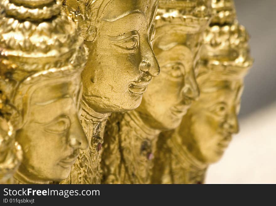 Statue of four golden buddha in a warm atmosphere