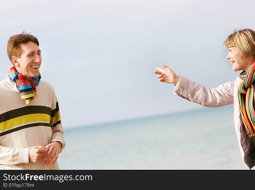 Young couple isolated over sky and sea background