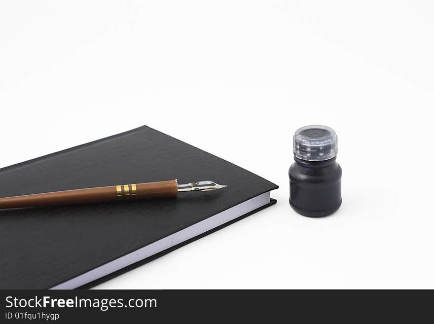 Notebook with pen and ink isolated on white