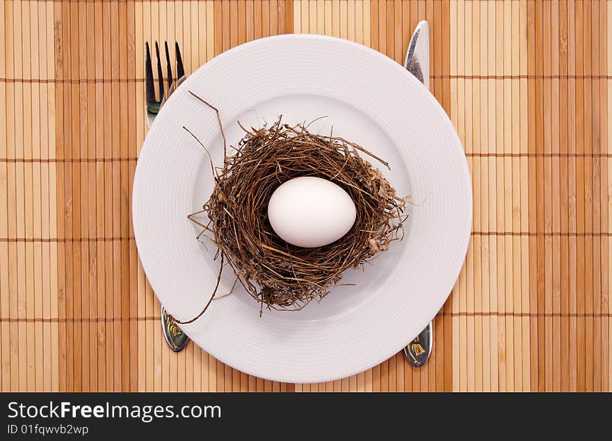 Egg in a nest served on a plate