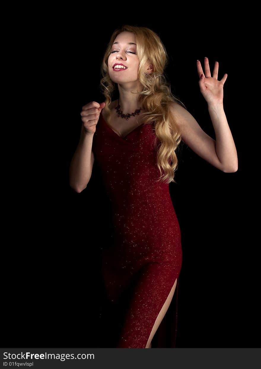 Beautiful blonde young lady in red dress singing. Beautiful blonde young lady in red dress singing