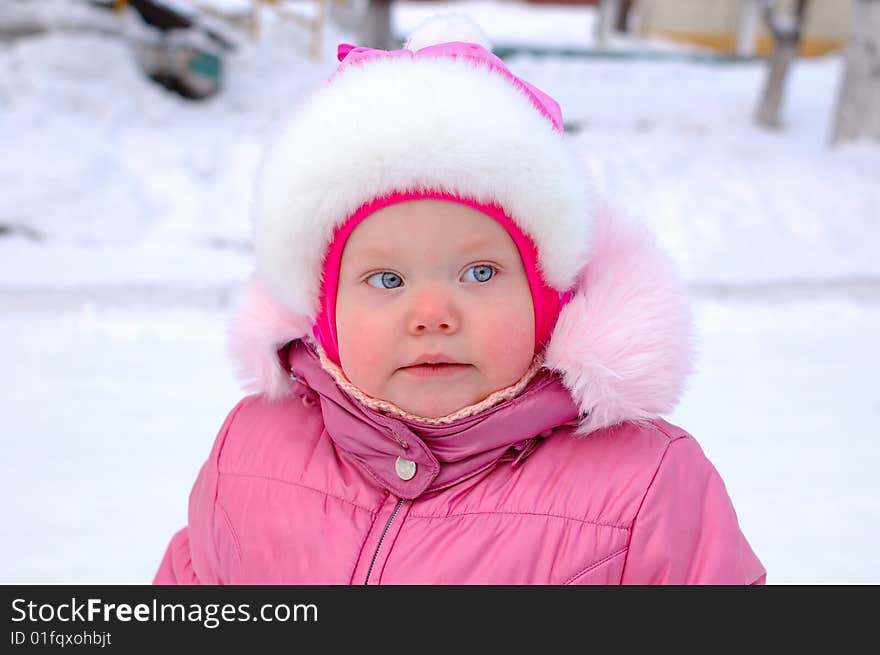 Pretty little girl in winter outerwear - outdoor portrait. Pretty little girl in winter outerwear - outdoor portrait.