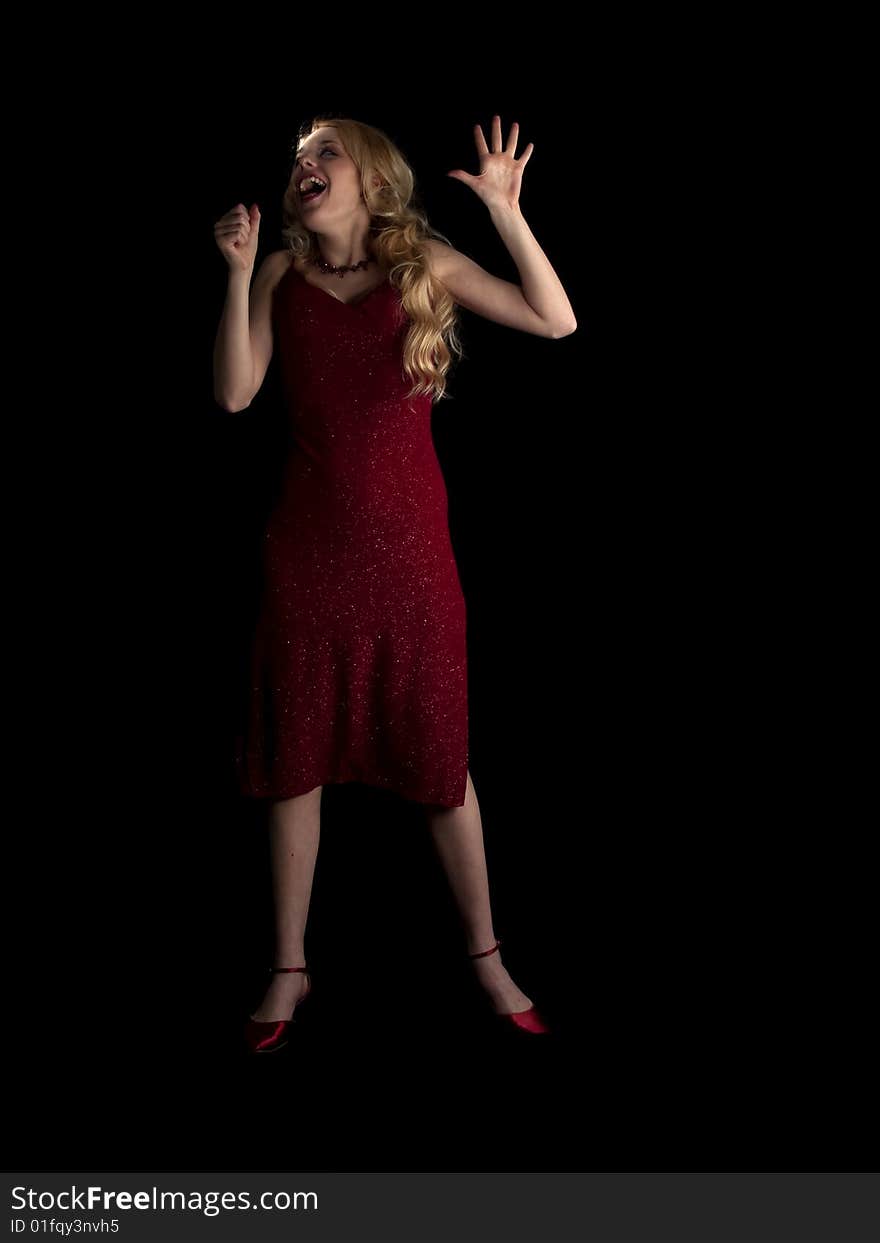 Beautiful blonde young lady in red dress singing. Beautiful blonde young lady in red dress singing