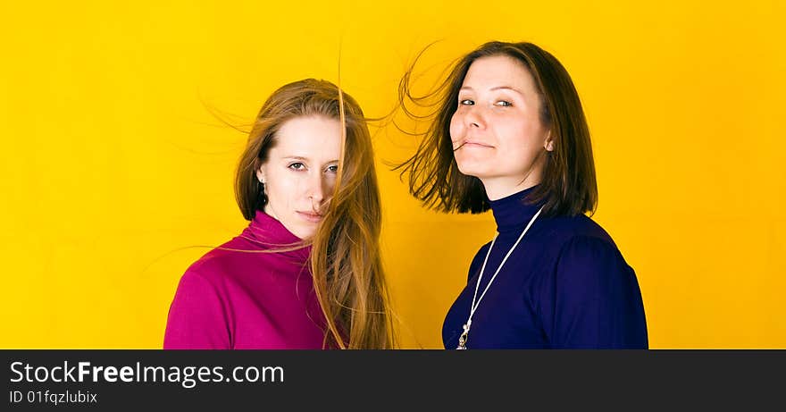 Close-up portrait of beautiful girl. Isolated over yellow background