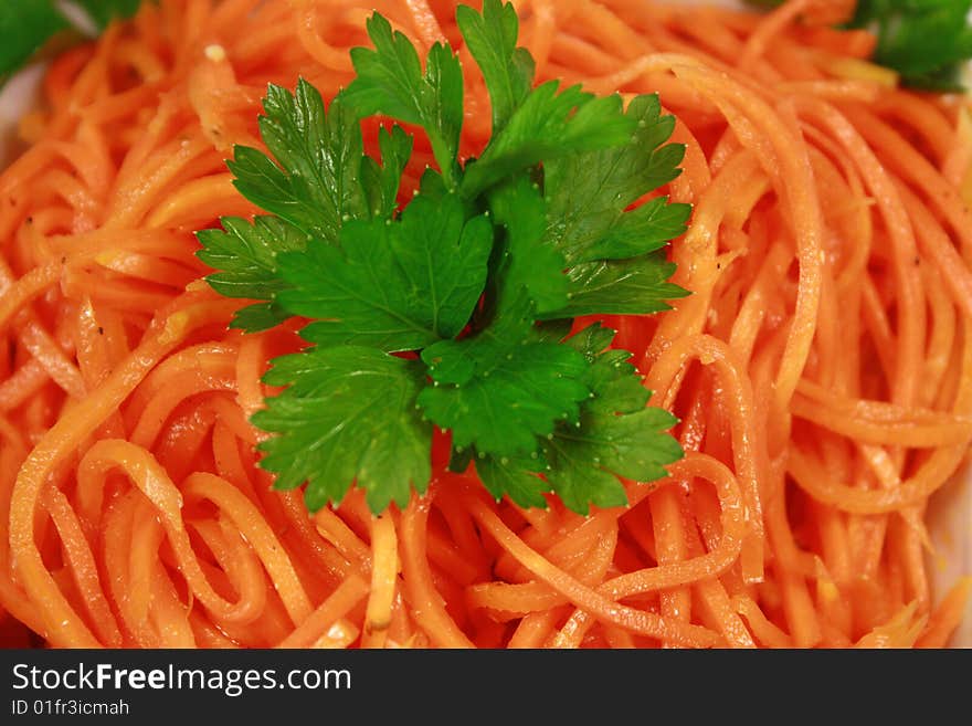 Lettuce from a carrot and parsley in a light-green dish. Lettuce from a carrot and parsley in a light-green dish