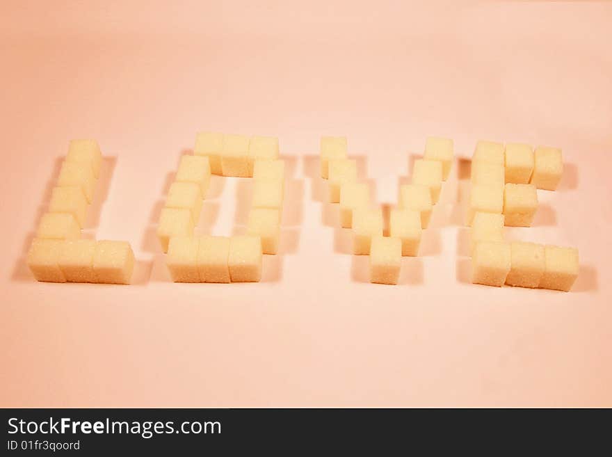 Word love maked from solid sugar cubes. Word love maked from solid sugar cubes