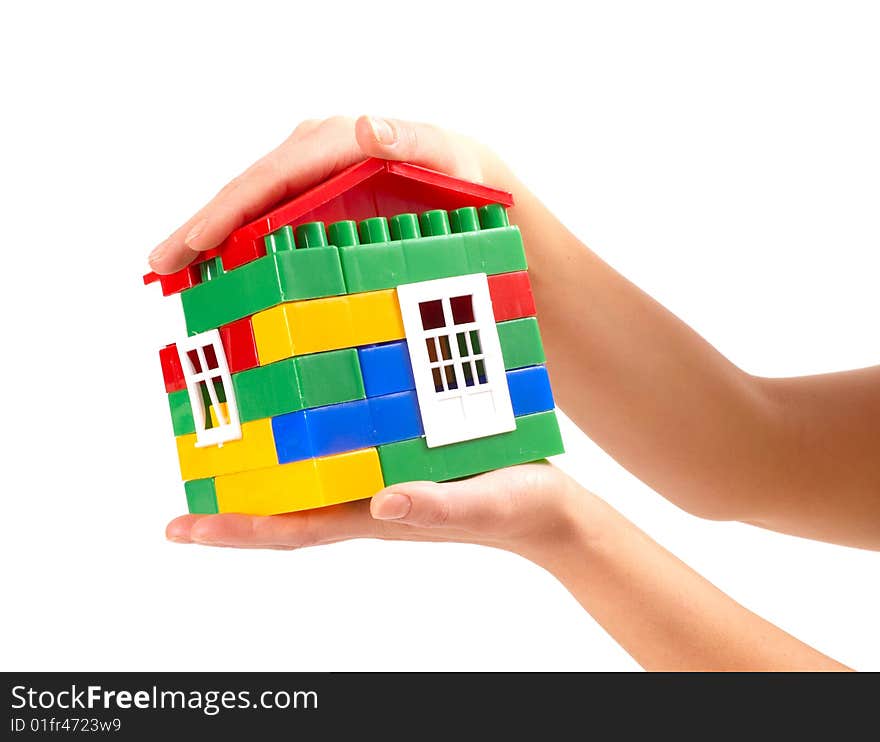 Small house in woman hands isolated on white