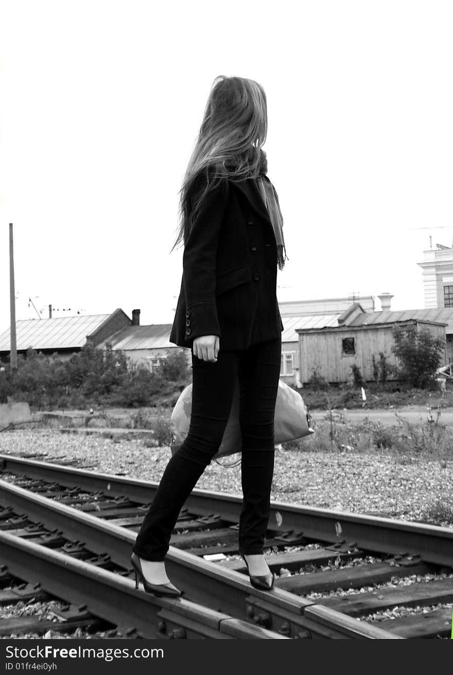 A girl travelling by railroad