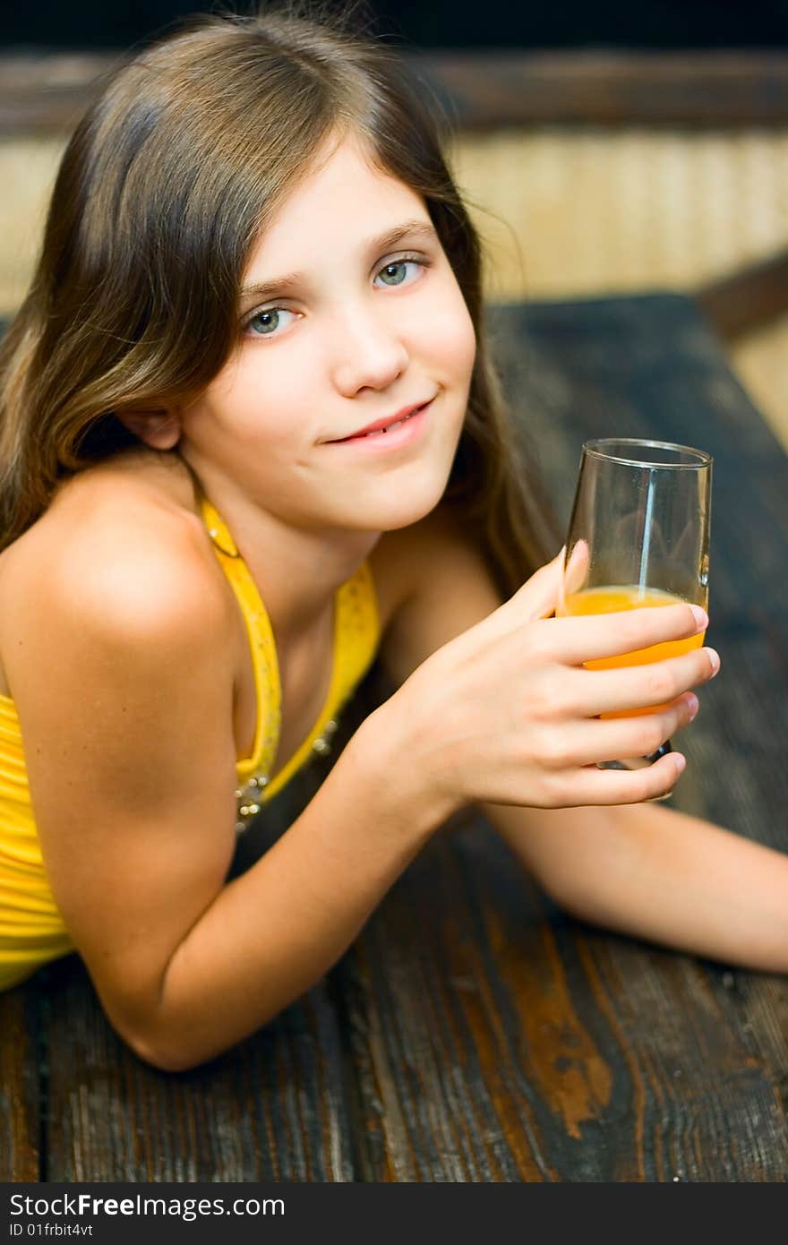 Pretty teen girl with juice in cafe