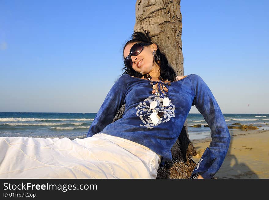 Trendy young fashion woman relaxing on tropical beach. Trendy young fashion woman relaxing on tropical beach