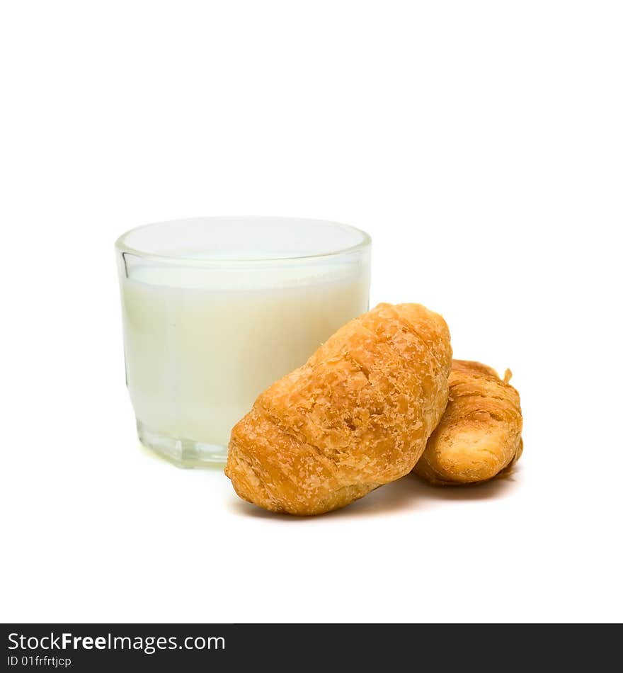 Glass with milk and cakes on plate isolated on white