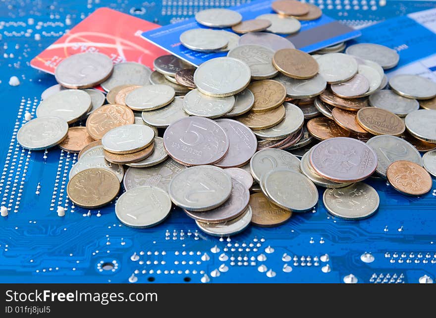 Technology business: money and credit cards on circuit board background