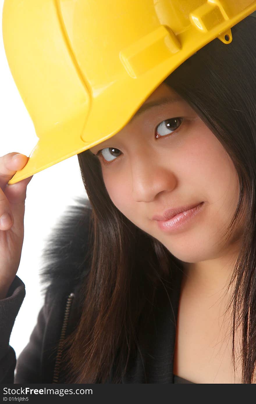 An attractive lady wearing a yellow hardhat. An attractive lady wearing a yellow hardhat.