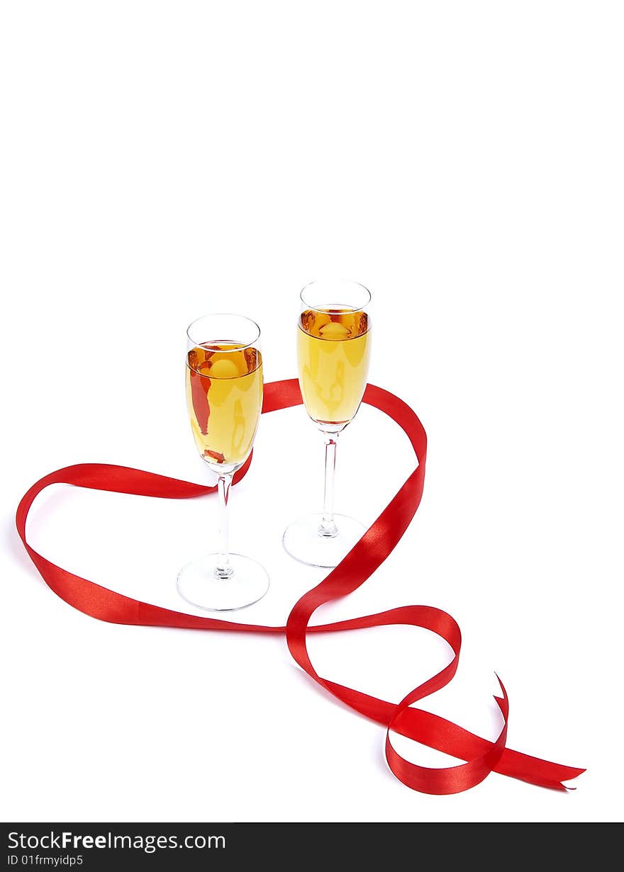 Two wine glasses and hearts from a red satiny tape. Two wine glasses and hearts from a red satiny tape