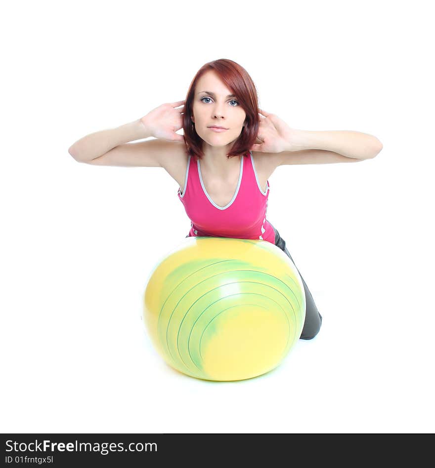 Young woman exercising with a pilates ball. Young woman exercising with a pilates ball