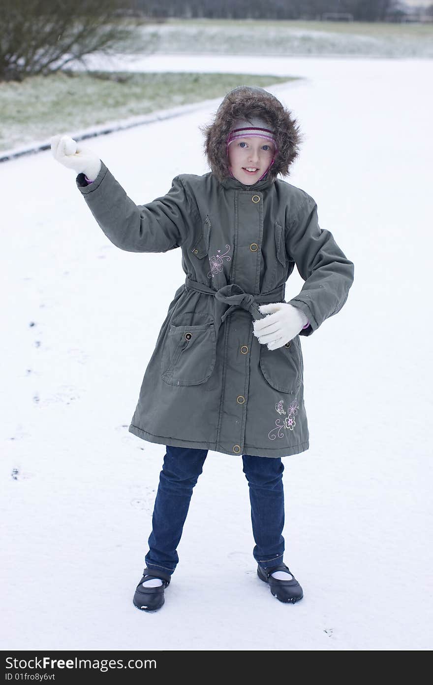 Young girl holding a snowball having fun. Young girl holding a snowball having fun