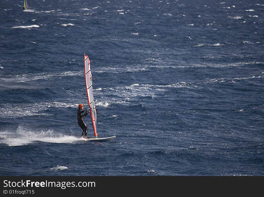 Wind surfer on blue sea. Wind surfer on blue sea