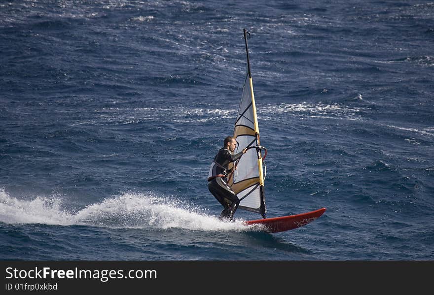 Wind surfer on blue sea. Wind surfer on blue sea