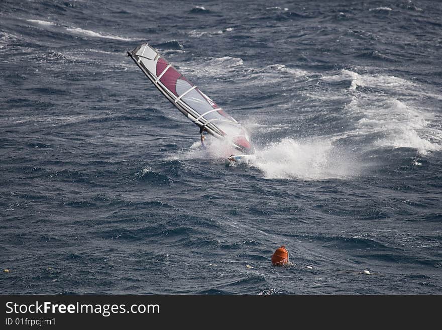 Wind surfer on blue sea. Wind surfer on blue sea