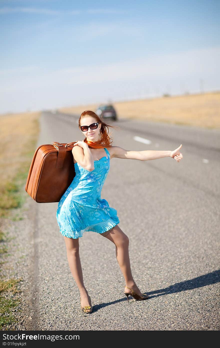 Girl on the road waiting for a car. Girl on the road waiting for a car