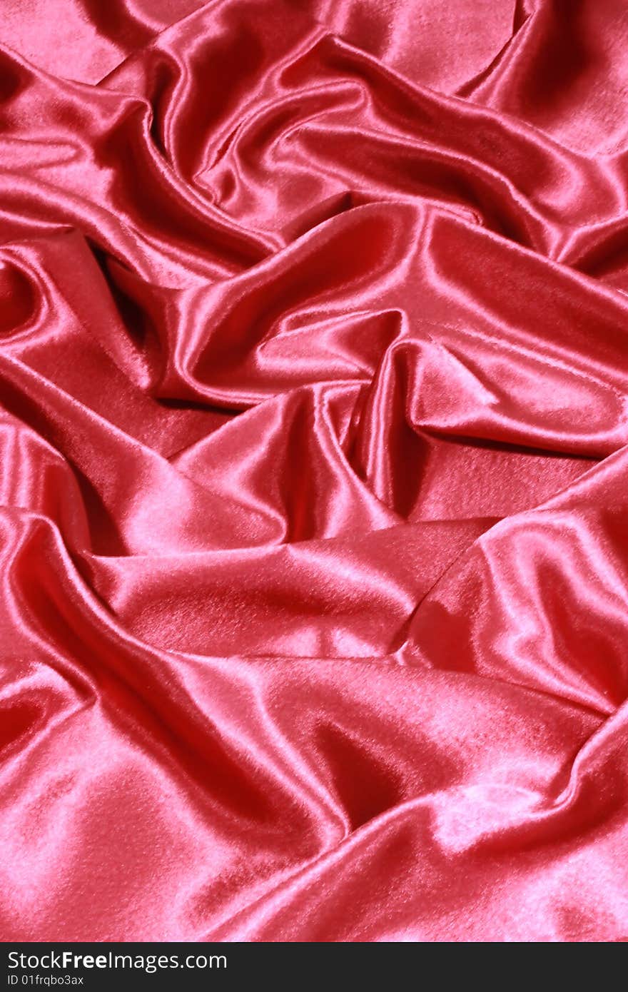 Brilliant silk fabric of red color. Atlas.